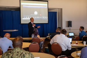Mr. Kent Miller, Naval Education and Training Command’s (NETC) executive director, speaks to learning standards officers (LSOs) at an offsite meeting aboard Naval Air Station Pensacola, June 14, 2022.