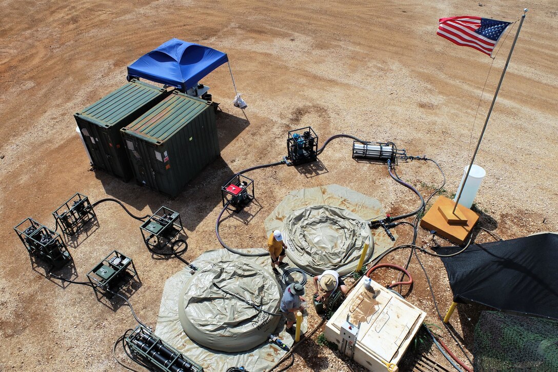 Aerial view of a water treatment system in a dirt field.