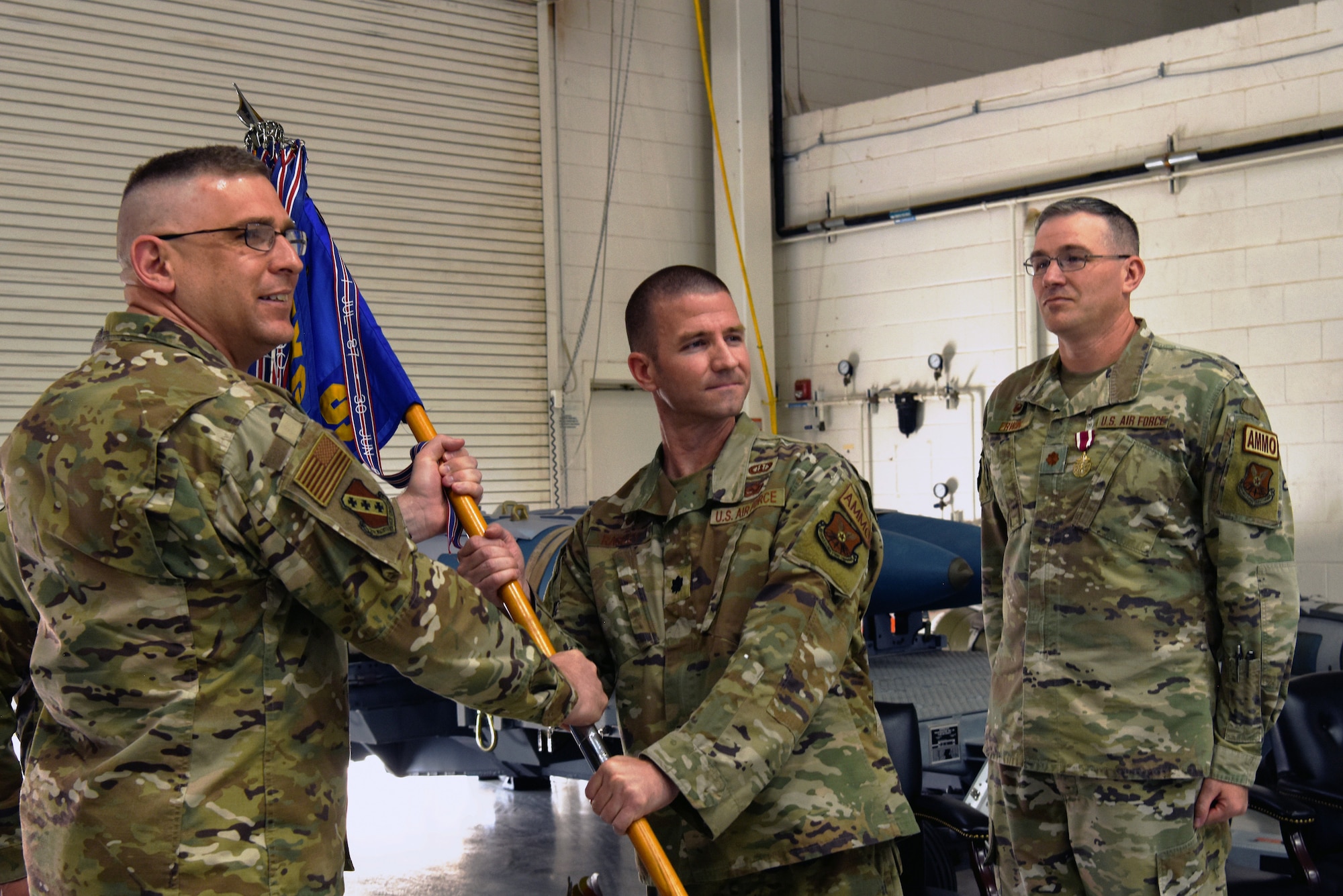 Lt. Col. Craig Rasley, incoming commander of the 7th Munitions Squadron, accepts the guidon on Dyess Air Force Base Texas, 16 Jun 2022. Changes of command in the military are a tradition that formally represent the transfer of authority from one leader to another. (U.S. Air Force photo by Senior Airman Sophia Robello)