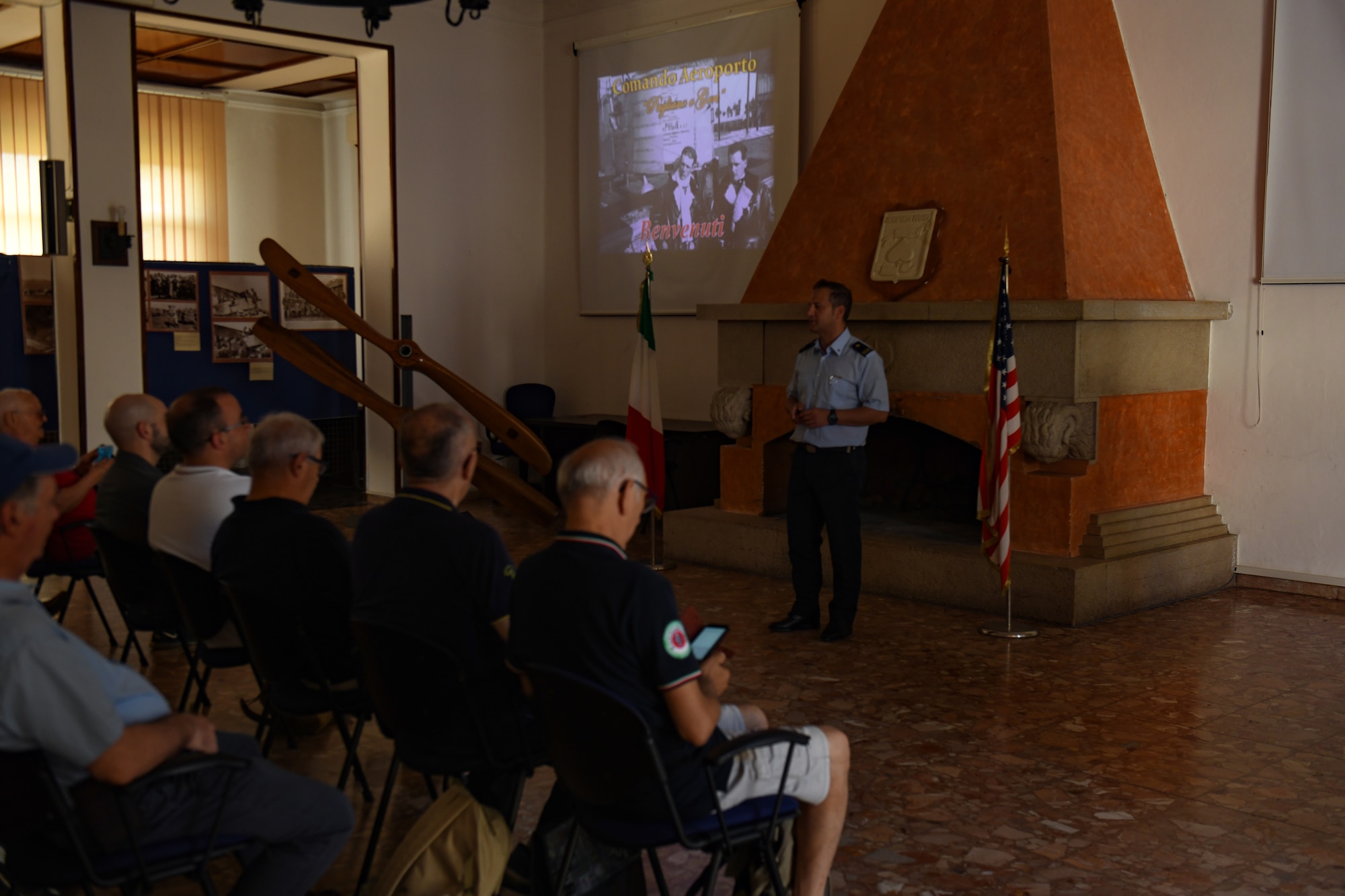 Italian air force Senior Master Sgt. Lorenzo Semeraro, ITAF command section member, briefs a tour group at Aviano Air Base, Italy, June 23, 2022. Base tours are offered to educate groups about the U.S. Air Force and Aviano AB missions. (U.S. Air Force photo by Senior Airman Thomas S. Keisler IV)