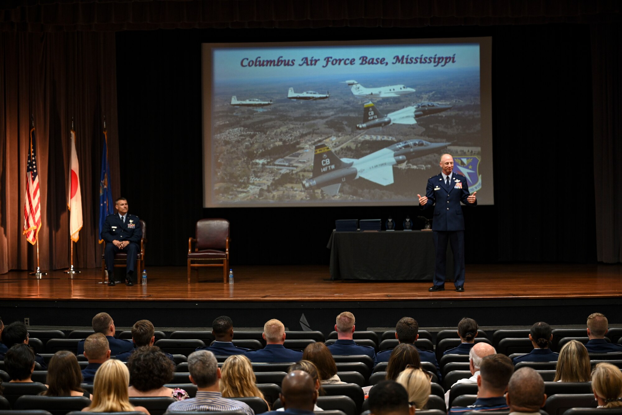 U.S. Air Force Col. Seth Graham, 14th Flying Training Wing commander, addresses the Specialized Undergraduate Pilot Training graduates from the stage where the pilots are about  to receive their first set of wings, June 17, 2022, on Columbus Air Force Base Miss. Graham received his commission from Oregon State University ROTC in 1998 and following his graduation he attended Specialized Undergraduate Pilot Training at Laughlin AFB, Texas. (U.S. Air Force photo by Airman 1st Class Jessica Blocher)