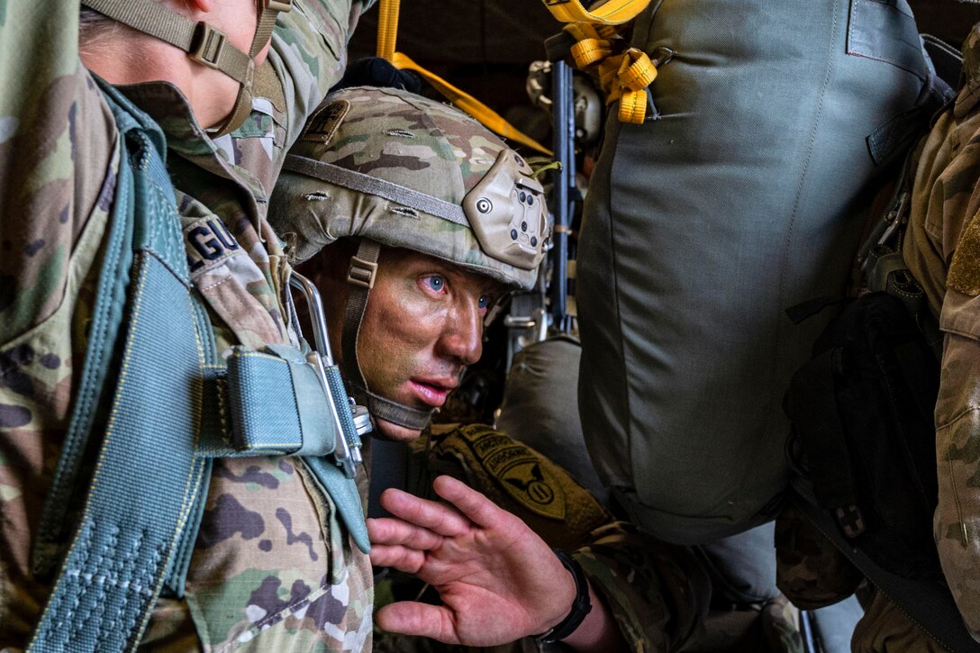 Soldiers stand in close together.