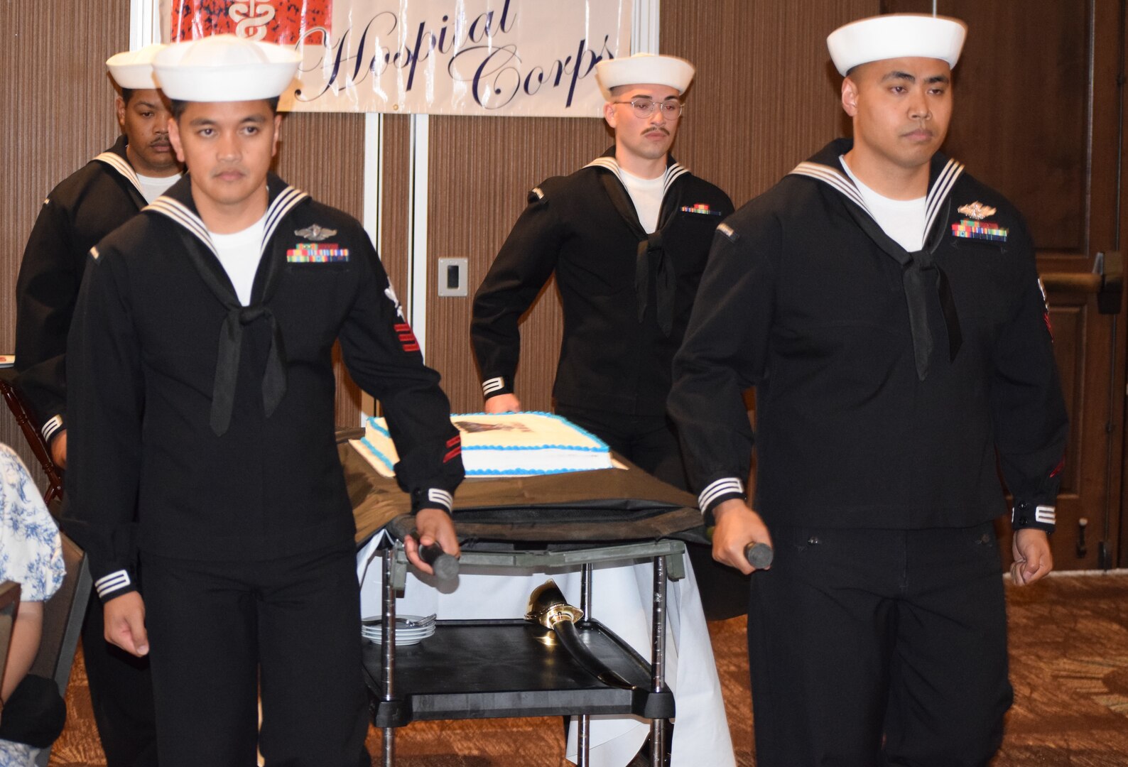 Cake forth...Navy Medicine Readiness Training Command Bremerton Senior Sailor of the Year, Hospital Corpsman 1st Class Sonnypaul Soriano (left front), along with Fiscal Year 2022 Sailors of the Quarter Hospital Corpsman 2nd Class Alexander Casaul (right front), Hospital Corpsman 3rd Class Aaron Foxworth, Jr. (back left) and Hospitalman Evan C. Gutierrez commence the traditional cake presentation during the command's Hospital Corps 124th birthday celebration held June 17, 2022 (Official Navy photo by Douglas H Stutz, NHB/NMRTC Bremerton public affairs officer).