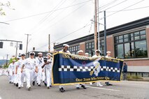 U.S. Navy Sailors, assigned to Zumwalt-class destroyer USS Michael Monsoor (DDG 1001), march together in the Rose Festival Parade during Portland Fleet Week in Oregon, June 11, 2022. Portland Fleet Week is a time-honored celebration of the sea services and provides an opportunity for the citizens of Oregon to meet Sailors, Marines and Coast Guardsmen, as well as witness firsthand the latest capabilities of today's maritime services. (U.S. Navy photo by Mass Communication Specialist Seaman Apprentice Sophia H. Brooks)