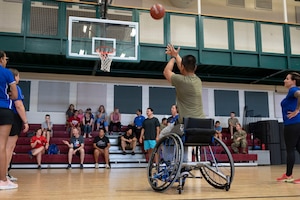 U.S. Airmen attempt modified basketball with the help of several Air Force Wounded Warrior
Program (AFW2) members at Laughlin Air Force Base, Texas, June 15, 2022. The AFW2 Program is a
Congressionally-mandated and Federally-funded organization tasked with taking care of U.S. Air Force
wounded, ill, and injured Airmen, Veterans, and their families. (U.S. Air Force photo by Airman 1st Class
Kailee Reynolds)