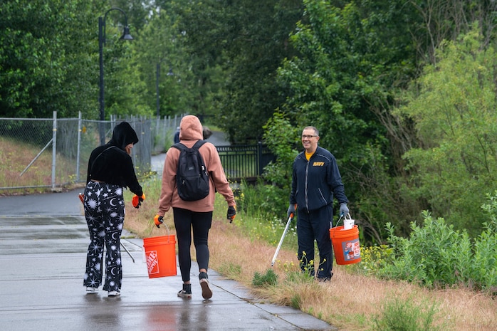 Gas Turbine Systems Technicians (Electrical) 3rd Class Alissa Montoya and Electrician’s Mate 3rd Class Sarah Allen, assigned to the Zumwalt-class destroyer USS Michael Monsoor (DDG 1001), and Lt. Phillip Webster, Navy Region Northwest Chaplain, pick up trash at Wintler Community Park during Portland Fleet Week 2022, June 12. Portland Fleet Week is a time-honored celebration of the sea services and provides an opportunity for the citizens of Oregon to meet Sailors, Marines and Coast Guardsmen, as well as witness firsthand the latest capabilities of today's maritime services. (U.S. Navy photo by Mass Communication Specialist 2nd Class Victoria Galbraith)