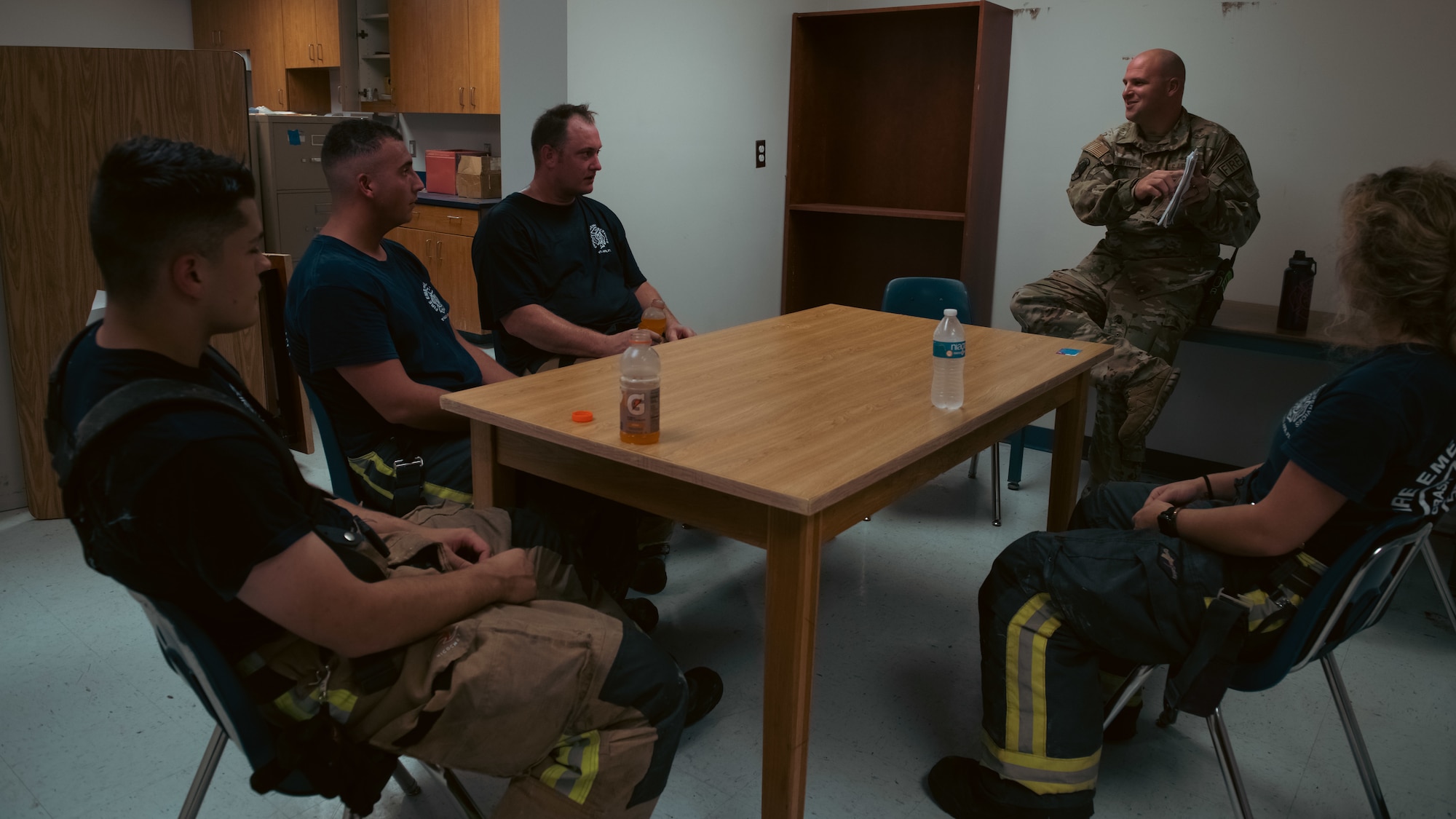 Firefighters talk in a group discussion.