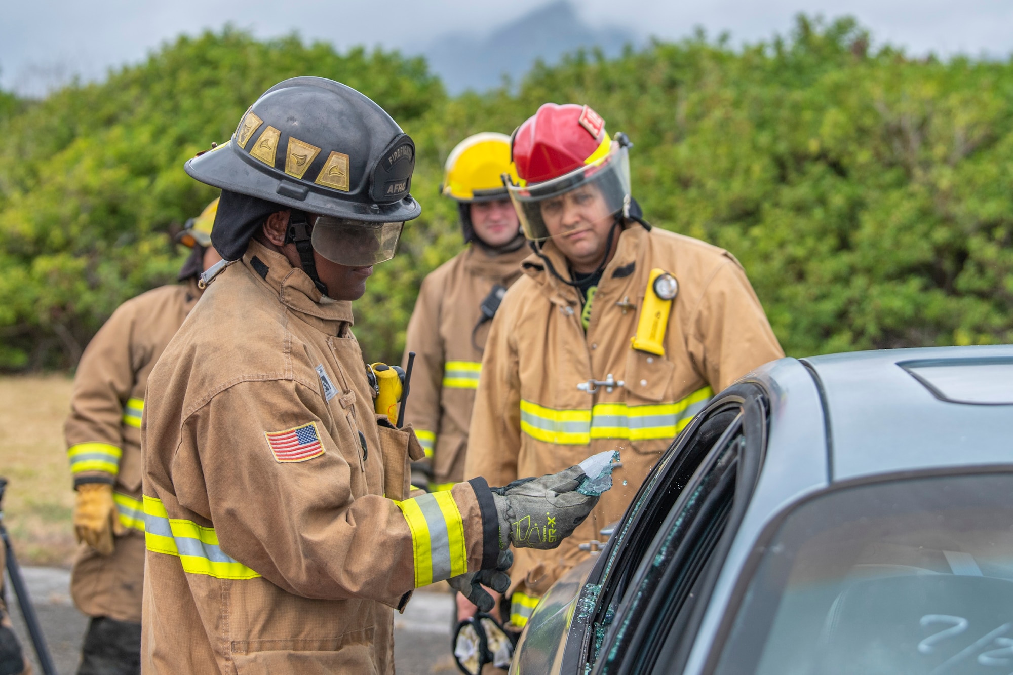 Senior Airman Josiah Williams, 624th Civil Engineering Squadron, participates in vehicle extrication training with U.S. Marines Aircraft Rescue and Federal Firefighters at MCAS Kaneohe Bay, Marine Corps Base Hawaii May 18, 2022.