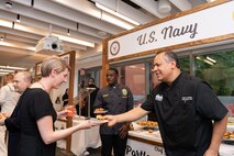 U.S. Navy culinary specialists and local Portland chefs pass out their sliders to judges at the annual Galley Wars during Portland Fleet Week in Oregon, June 9, 2022. Portland Fleet Week is a time-honored celebration of the sea services and provides an opportunity for the citizens of Oregon to meet Sailors, Marines and Coast Guardsmen, as well as witness firsthand the latest capabilities of today's maritime services. (U.S. Navy photo by Mass Communication Specialist Seaman Apprentice Sophia H. Brooks)