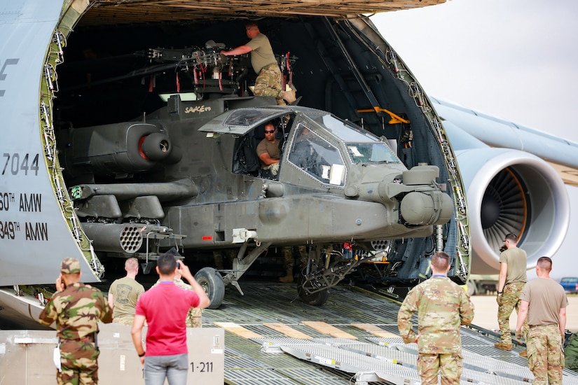 U.S. Soldiers from the 1-211th Aviation Regiment, Utah Army National Guard, unload an AH-64 Apache helicopter on June 20, 2022, at Agadir Al-Massira International Airport, Morocco.