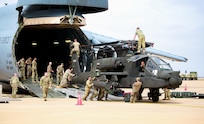 U.S. Soldiers from the 1-211th Aviation Regiment, Utah Army National Guard, unload an AH-64 Apache helicopter on June 20, 2022, at Agadir Al-Massira International Airport, Morocco.