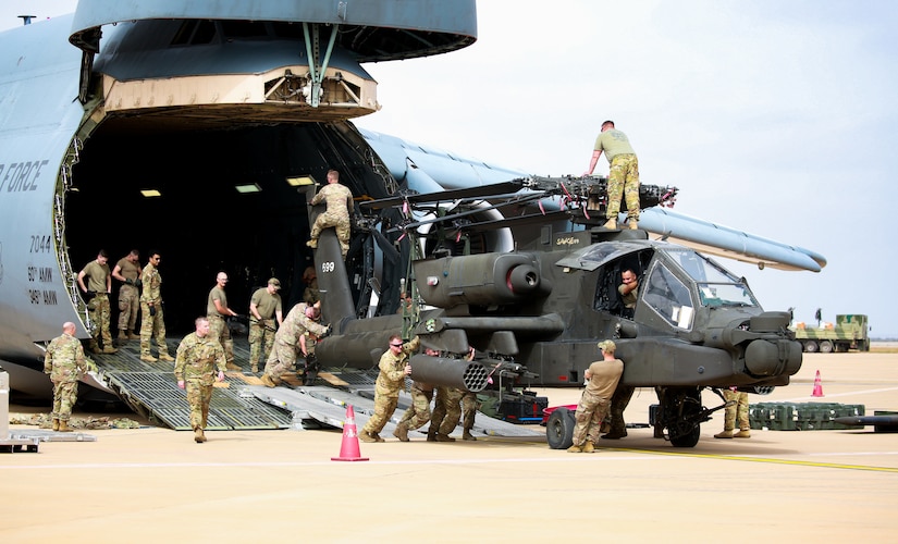 U.S. Soldiers from the 1-211th Aviation Regiment, Utah Army National Guard, unload an AH-64 Apache helicopter on June 20, 2022, at Agadir Al-Massira International Airport, Morocco.