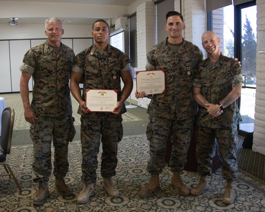 U.S. Marine Corps 1st Lt. Dallas Frye, an Infantry officer, and Sgt. Eddie Mims, a rifleman with 1st Battalion, 1st Marine Regiment, 1st Marine Division (1st MARDIV), pose for a picture after receiving a Navy and Marine Corps Achievement Medal during the 2022 Active Duty Fund Drive (ADFD) close-out ceremony at Marine Corps Base Camp Pendleton, California, June 21, 2022.  At the end of each ADFD season,  Navy-Marine Corps Relief Society offices around the world host appreciation ceremonies recognizing commands with the highest donation. (U.S. Marine Corps photo by Lance Cpl. Jaye Townsend)