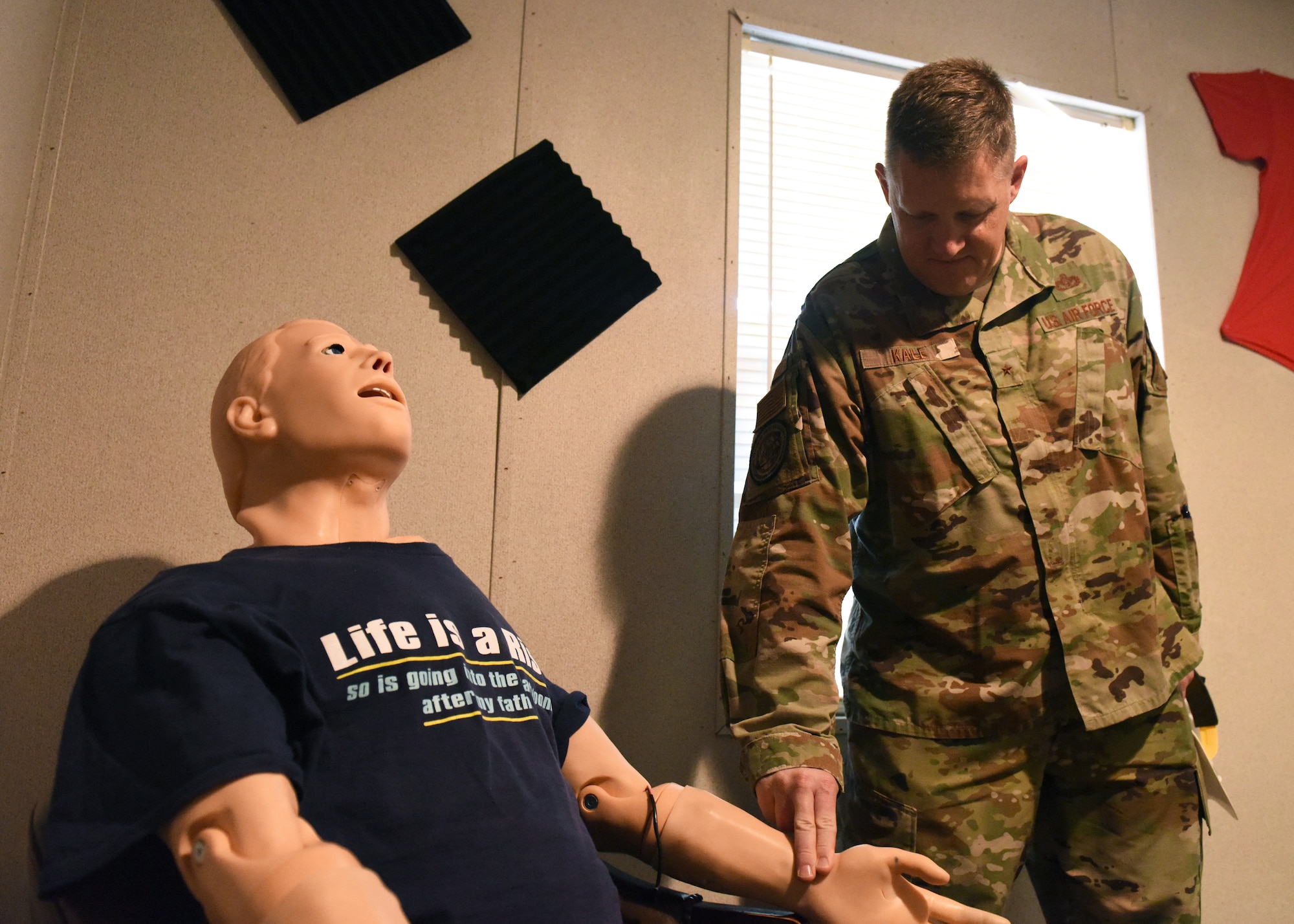 U.S. Air Force Brig. Gen. William Kale III, Air Force Director of Civil Engineers, checks the pulse on a HAL Manikin at Goodfellow Air Force Base, Texas, June 23, 2022. The simulator can display a pulse, dilate pupils and use blue lights in the face to represent cyanotic conditions. (U.S. Air Force photo by Airman 1st Class Zachary Heimbuch)