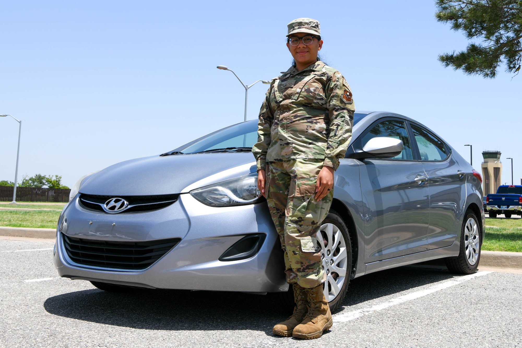 U.S. Air Force Airman 1st Class Maria Juanico, 97th Operations Support Squadron intel analyst, poses for a photo at Altus Air Force Base, Oklahoma, June 14, 2022. The A&FRC financial program provided Juanico with tips on saving money and avoiding loans for larger expenses, helping her buy a car with cash. (U.S. Air Force photo by Airman 1st Class Trenton Jancze)