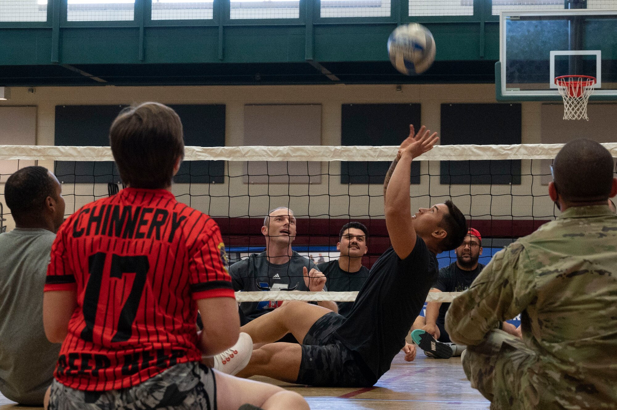 U.S. Air Force SrA Jude Cruz, 47th Operations Support Squadron aerospace physiology
technician, hits a volleyball into the air during an Air Force Wounded Warrior Program (AFW2) hosted
sitting-volleyball tournament at Laughlin Air Force Base, Texas, June 15, 2022. The AFW2 Program is a
Congressionally-mandated and Federally-funded organization tasked with taking care of U.S. Air Force
wounded, ill, and injured Airmen, Veterans, and their families. (U.S. Air Force photo by Airman 1st Class
Kailee Reynolds)