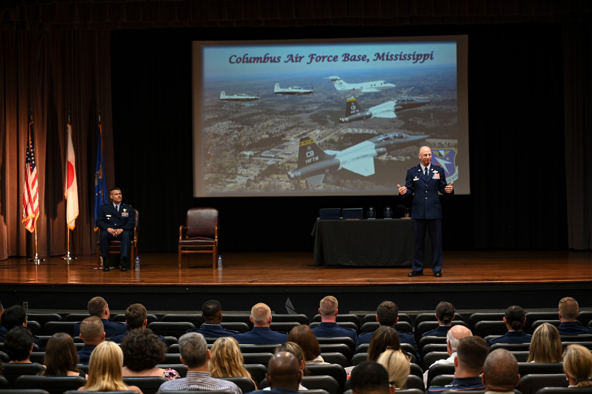 U.S. Air Force Col. Seth Graham, 14th Flying Training Wing commander, addresses the Specialized Undergraduate Pilot Training graduates from the stage where the pilots are about  to receive their first set of wings, June 17, 2022, on Columbus Air Force Base Miss. Graham received his commission from Oregon State University ROTC in 1998 and following his graduation he attended Specialized Undergraduate Pilot Training at Laughlin AFB, Texas. (U.S. Air Force photo by Airman 1st Class Jessica Blocher)