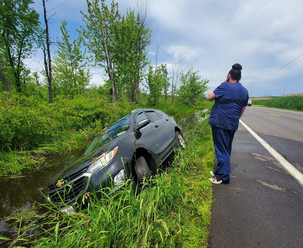 After being helped from the pictured vehicle by OSI Special Agent Damian Lonergan on June 15, 2022, the driver assesses the situation after veering off Minoa Road into the Cicero Swamp Wildlife Management Area eastbound towards Bridgeport, N.Y. (Photo by SA Damian Lonergan, OSI PF Det. 6, OL-C)