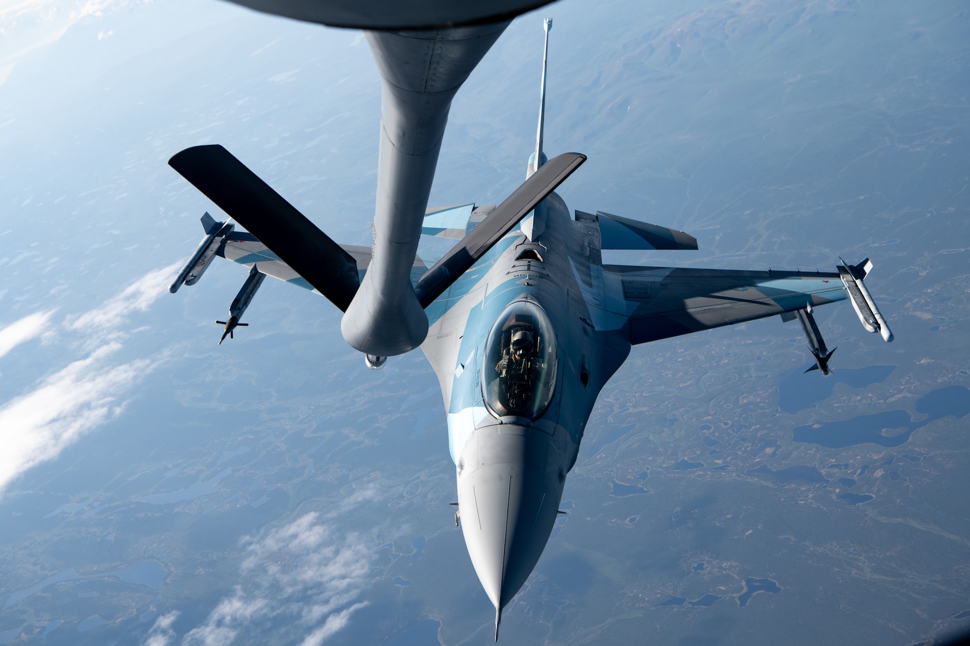 An F-16 performs aerial refueling operations.
