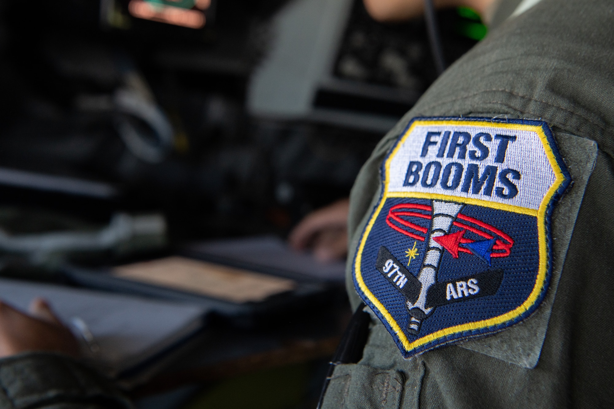 A 92nd Airlift Squadron Boom Operator patch is featured on an Airman's shoulder