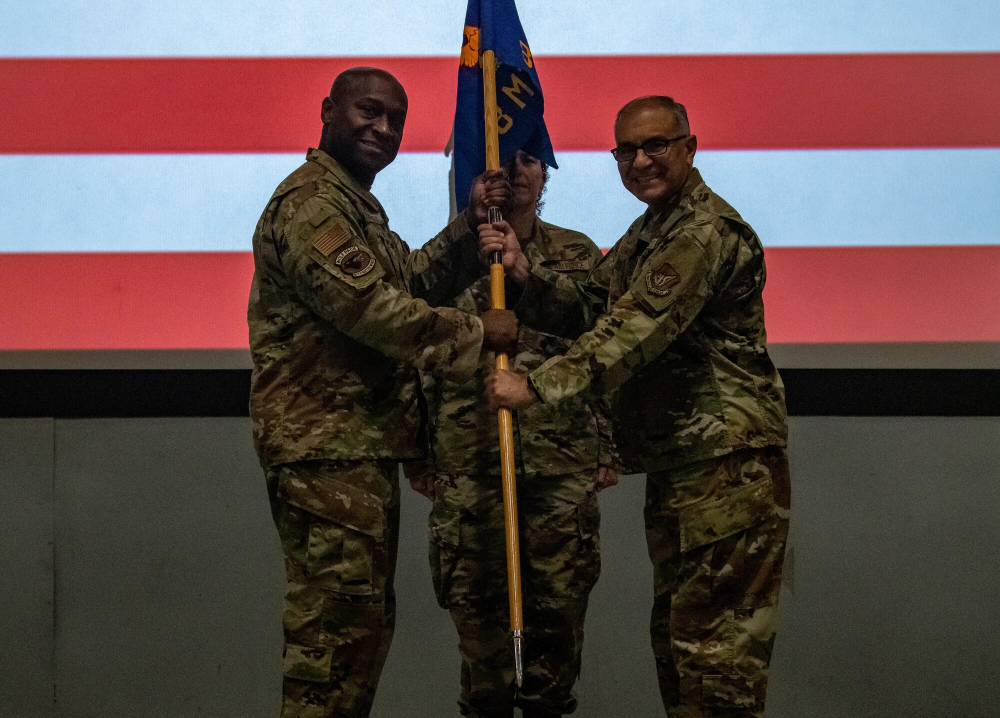 Military Members conduct a ceremony with a guidon (flag)