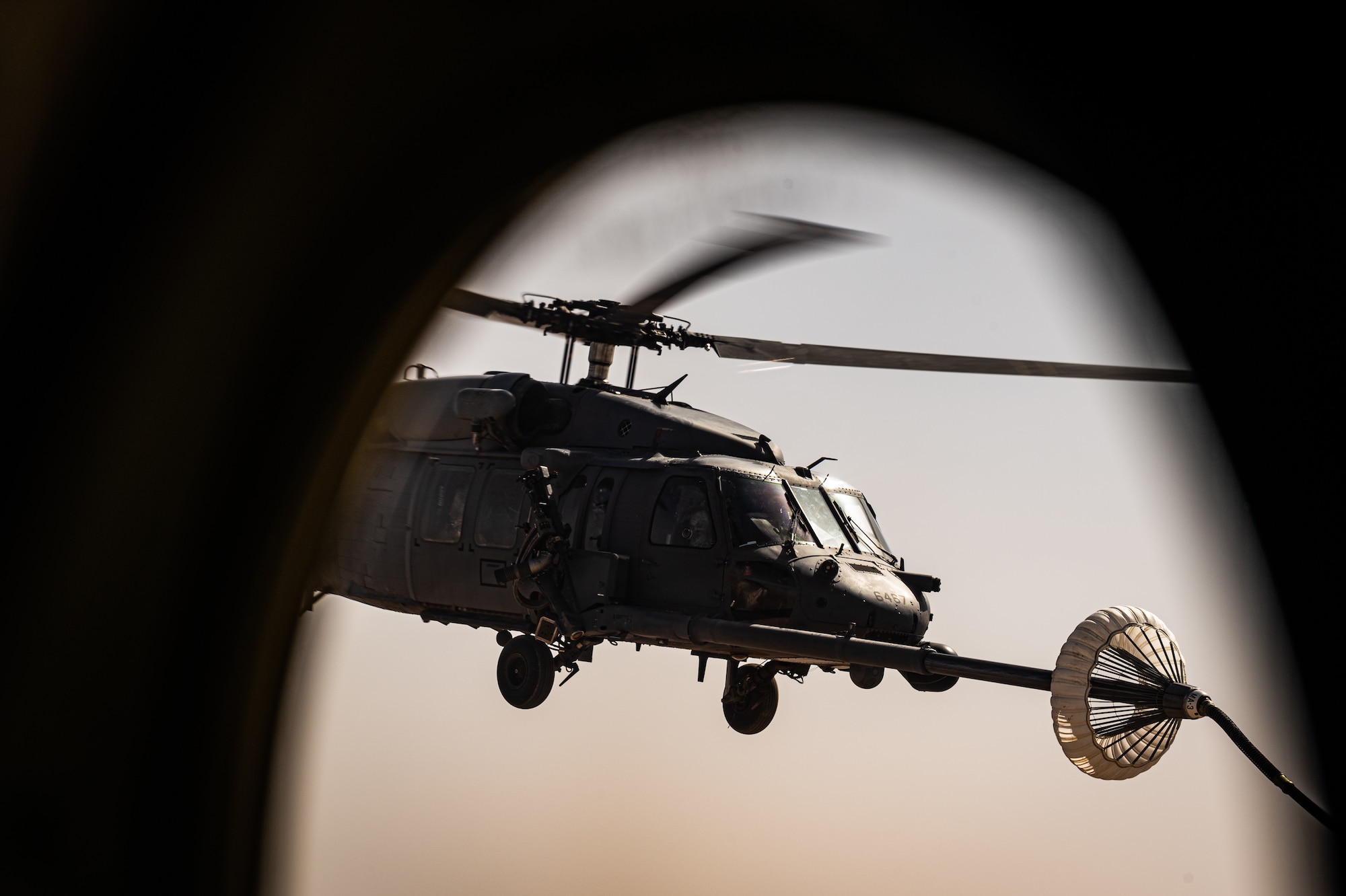 A 332d Air Expeditionary Wing HH-60G Pave Hawk helicopter receives fuel from an HC-130J Combat King II aircraft, also assigned to the 332d AEW, in Southwest Asia June 12, 2022. The primary mission of the Pave Hawk is to conduct day or night personnel recovery operations into hostile environments to recover isolated personnel during conflict. The HH-60G is also tasked to perform military operations other than conflict, including civil search and rescue, medical evacuation, disaster response, humanitarian assistance, security cooperation/aviation advisory, NASA space flight support, and rescue command and control. (U.S. Air Force photo by Master Sgt. Christopher Parr)