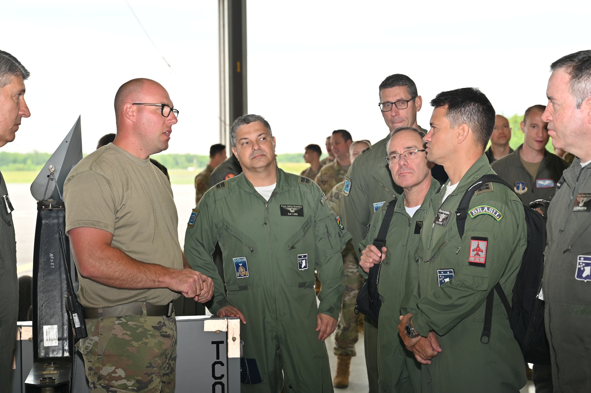 HANCOCK FIELD AIR NATIONAL GUARD BASE, SYRACUSE, NY. --  Master Sgt. Eric Wintersteen, a crew chief with the 174th Maintenance Group, is explaining how he is performing an airframe and engine inspection on the MQ-9 reaper to members from the Brazilian military on June 6, 2022 at Hancock Field Air National Guard base. The Brazilian military’s purpose for the visit is to strengthen the partnership between the New York Air National Guard and the Brazilian Air Force Aerospace Operations Command. (U.S. Air National Guard photo by Master Sgt. Barbara Olney)
