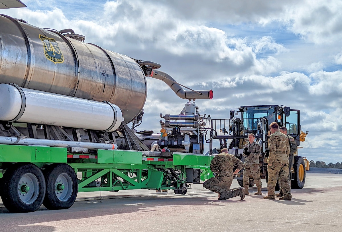 Airmen load tank onto plane