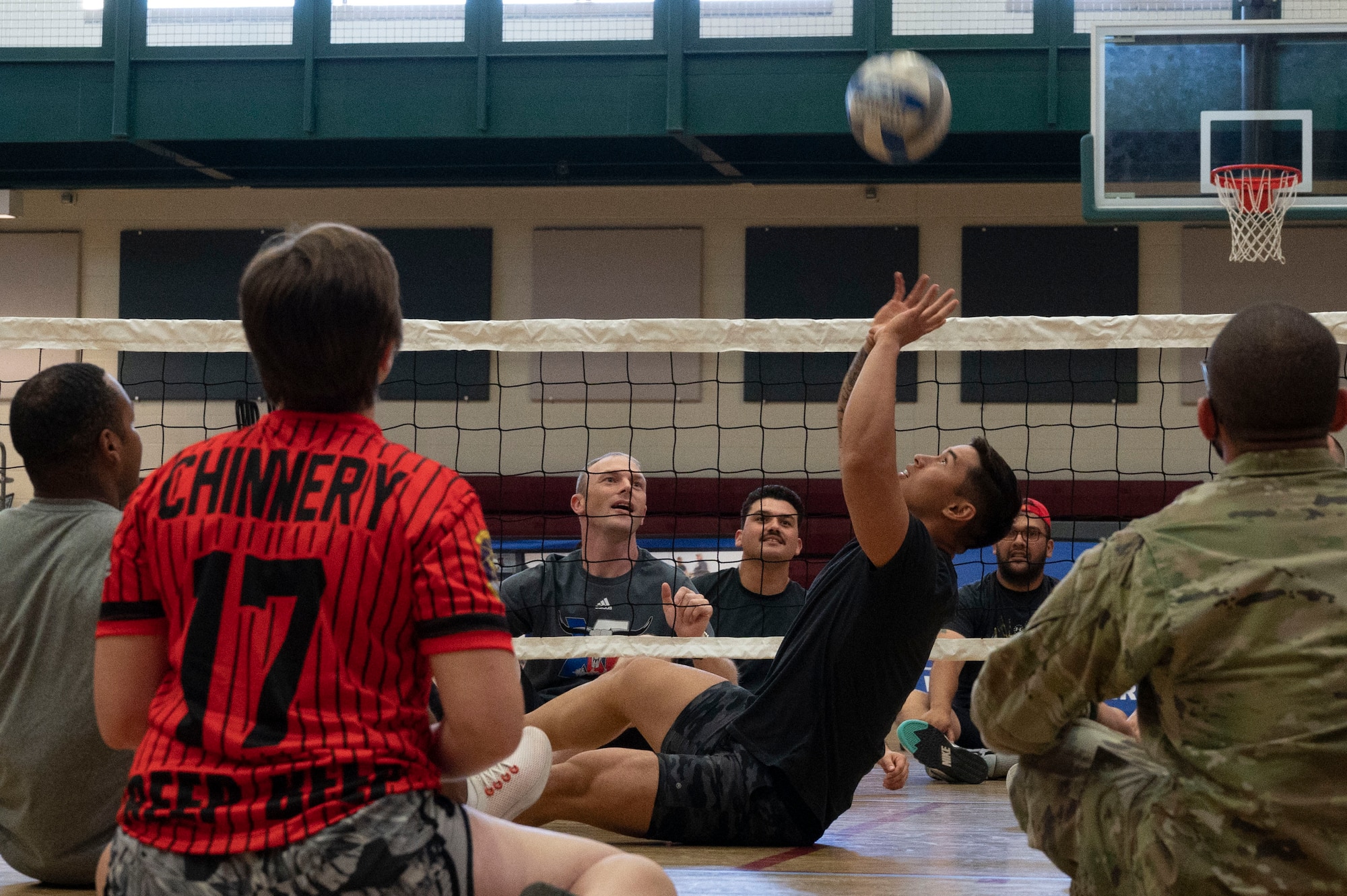 U.S. Air Force SrA Jude Cruz, 47th Operations Support Squadron aerospace physiology
technician, hits a volleyball into the air during an Air Force Wounded Warrior Program (AFW2) hosted
sitting-volleyball tournament at Laughlin Air Force Base, Texas, June 15, 2022. The AFW2 Program is a
Congressionally-mandated and Federally-funded organization tasked with taking care of U.S. Air Force
wounded, ill, and injured Airmen, Veterans, and their families. (U.S. Air Force photo by Airman 1st Class
Kailee Reynolds)