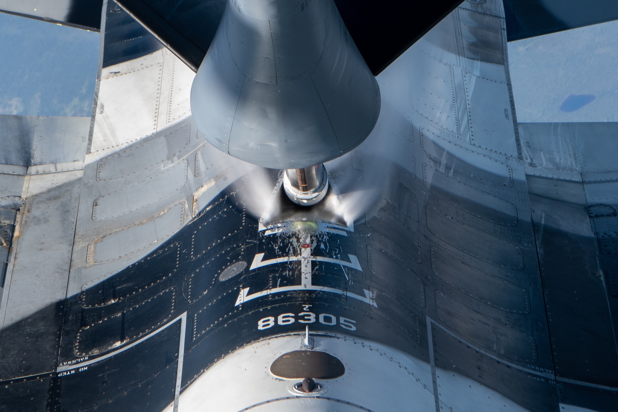 An F-16 performs aerial refueling operations.