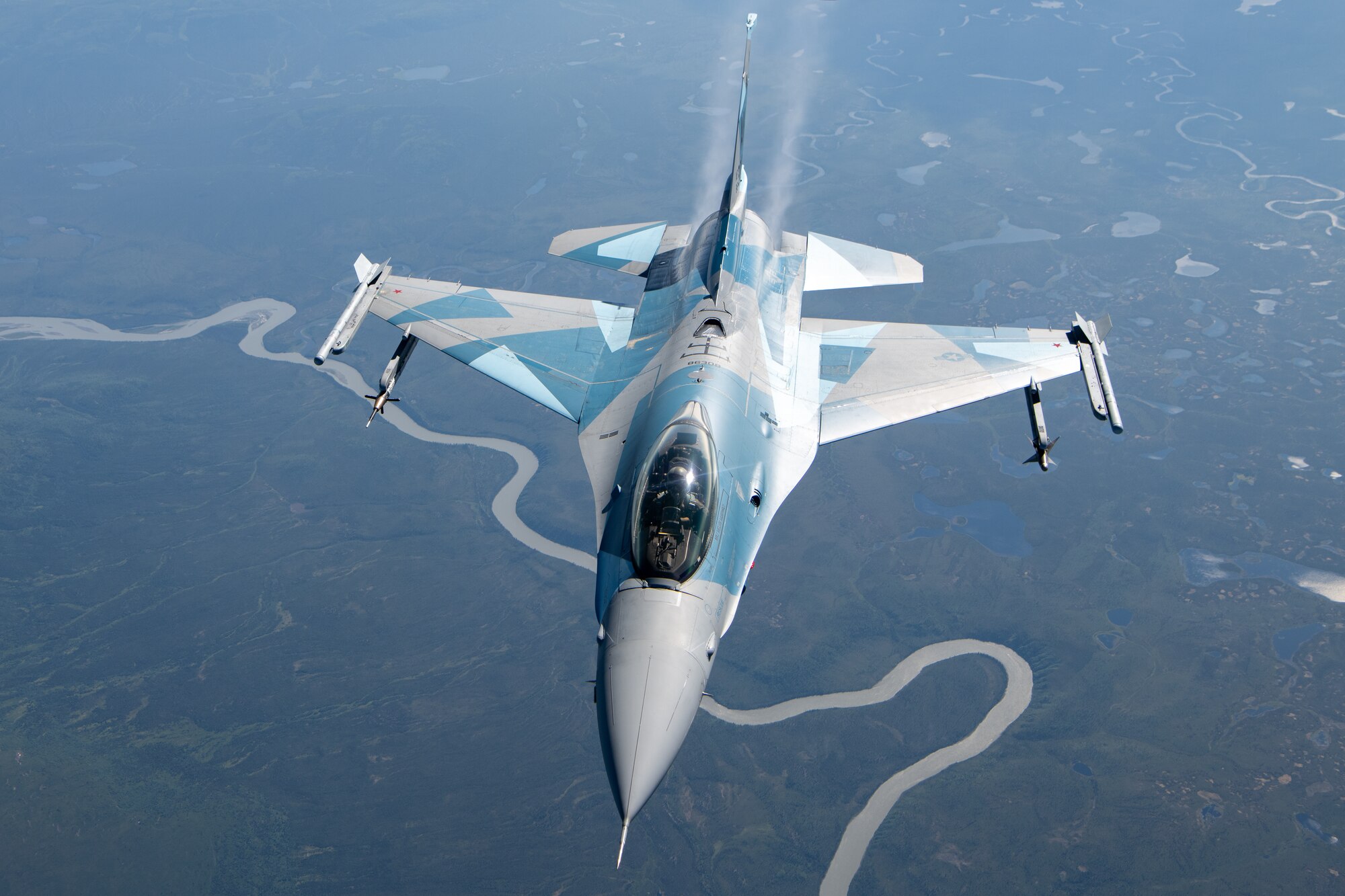 An F-16 performs aerial refueling operations.