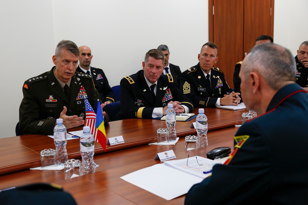 A group of people sit around a large table.