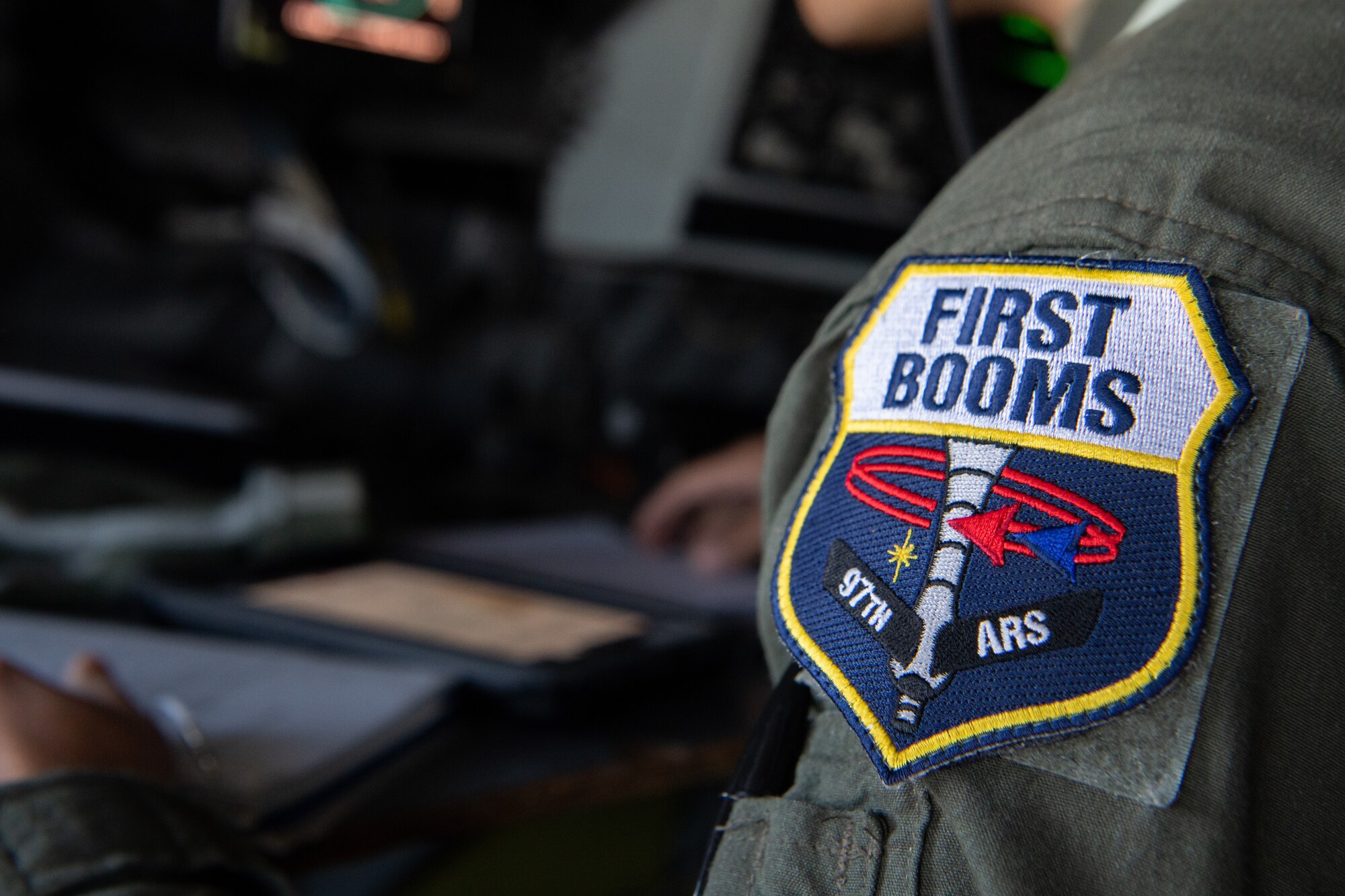 A 92nd Airlift Squadron Boom Operator patch is featured on an Airman's shoulder