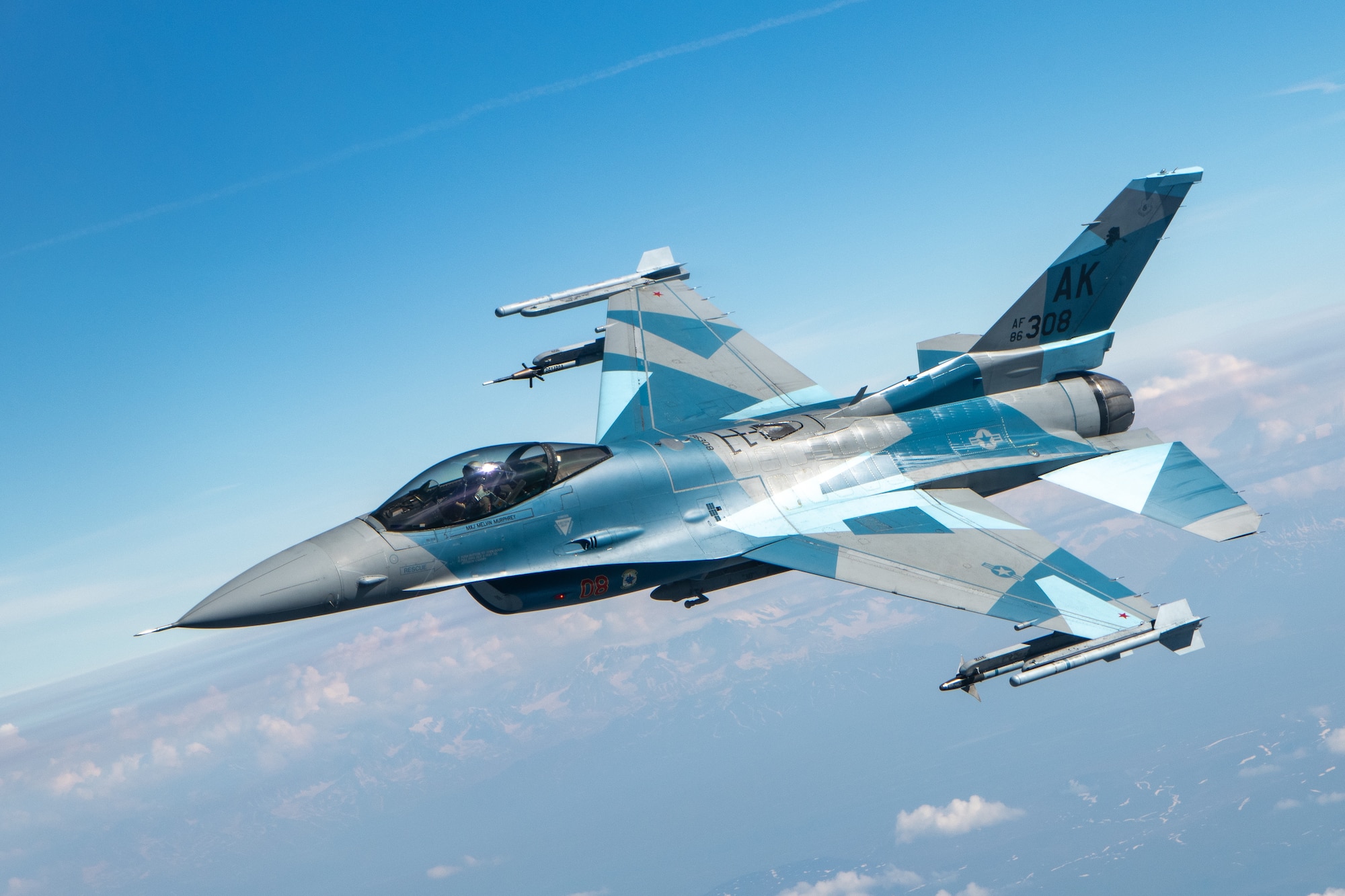 An F-16 performs aerial refueling operations.