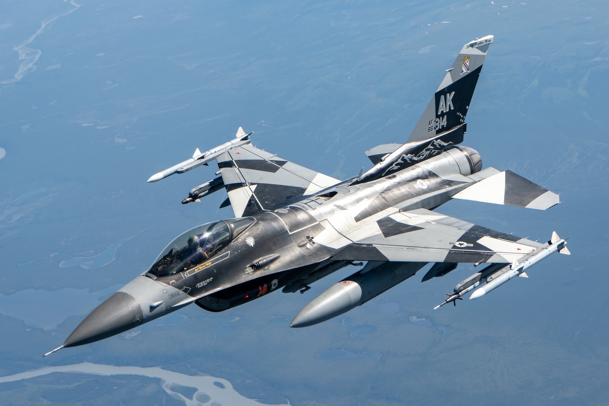 An F-16 performs aerial refueling operations.