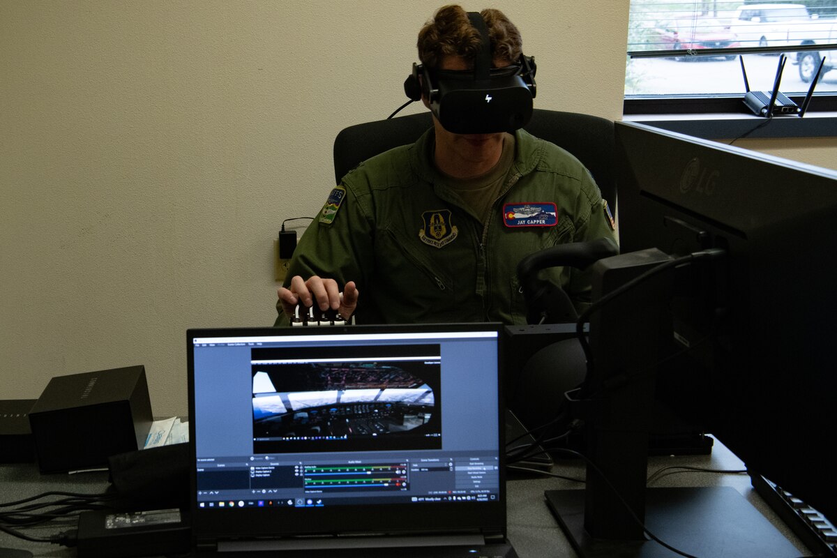 Pilot operates VR headset during flight training scenario