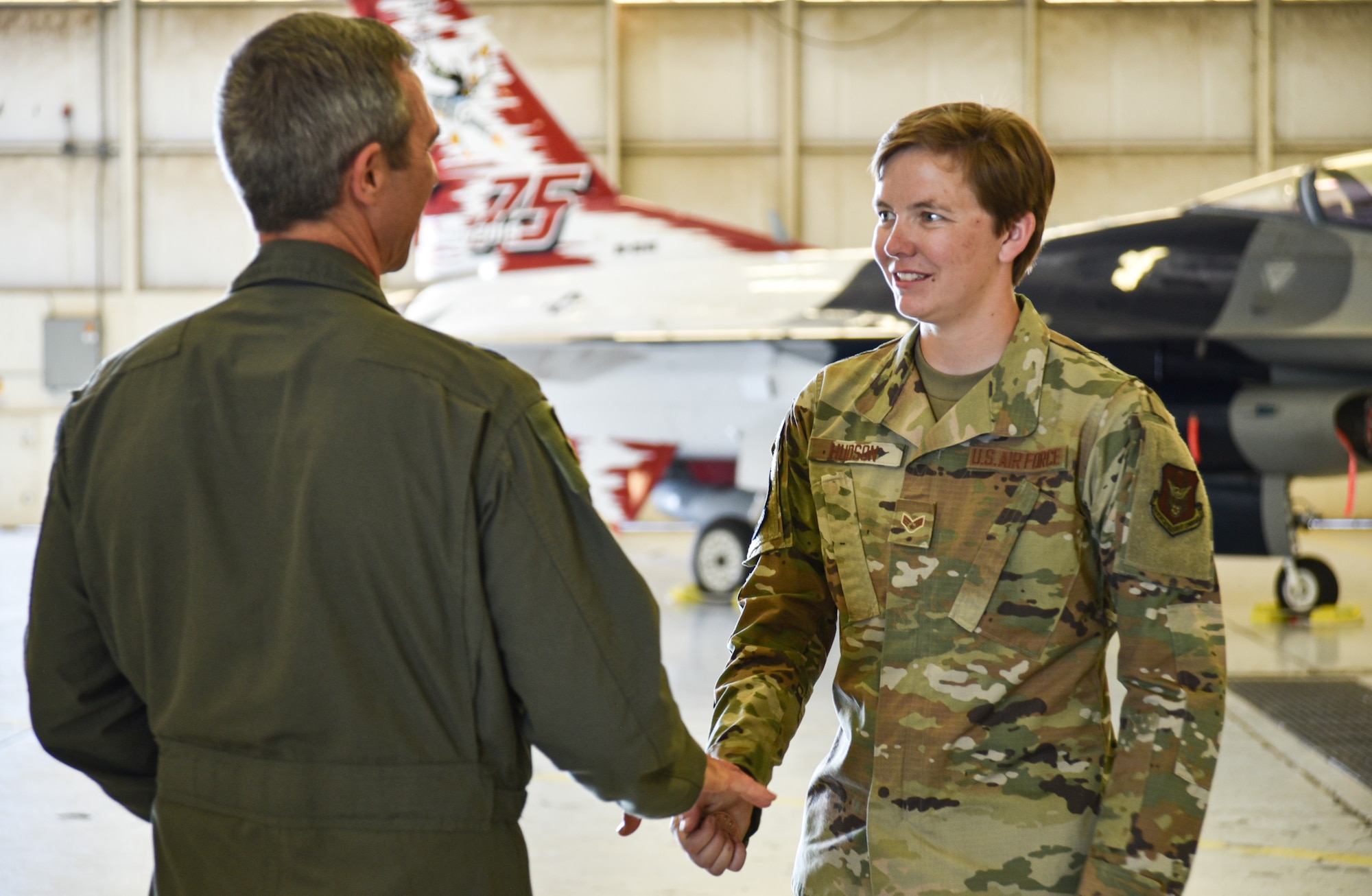 Maj. Gen Bryan R. Radliff (left), 10th Air Force commander, coins SrA Hannah Hudson, 301 Fighter Wing Aircraft Maintenance Squadron crew chief at Naval Air Station Joint Reserve Base Fort Worth, Texas, June 5, 2022. Radliff coined Hudson for her exceptional performance within the workplace. (U.S Air Force photo by Senior Airman William Downs)