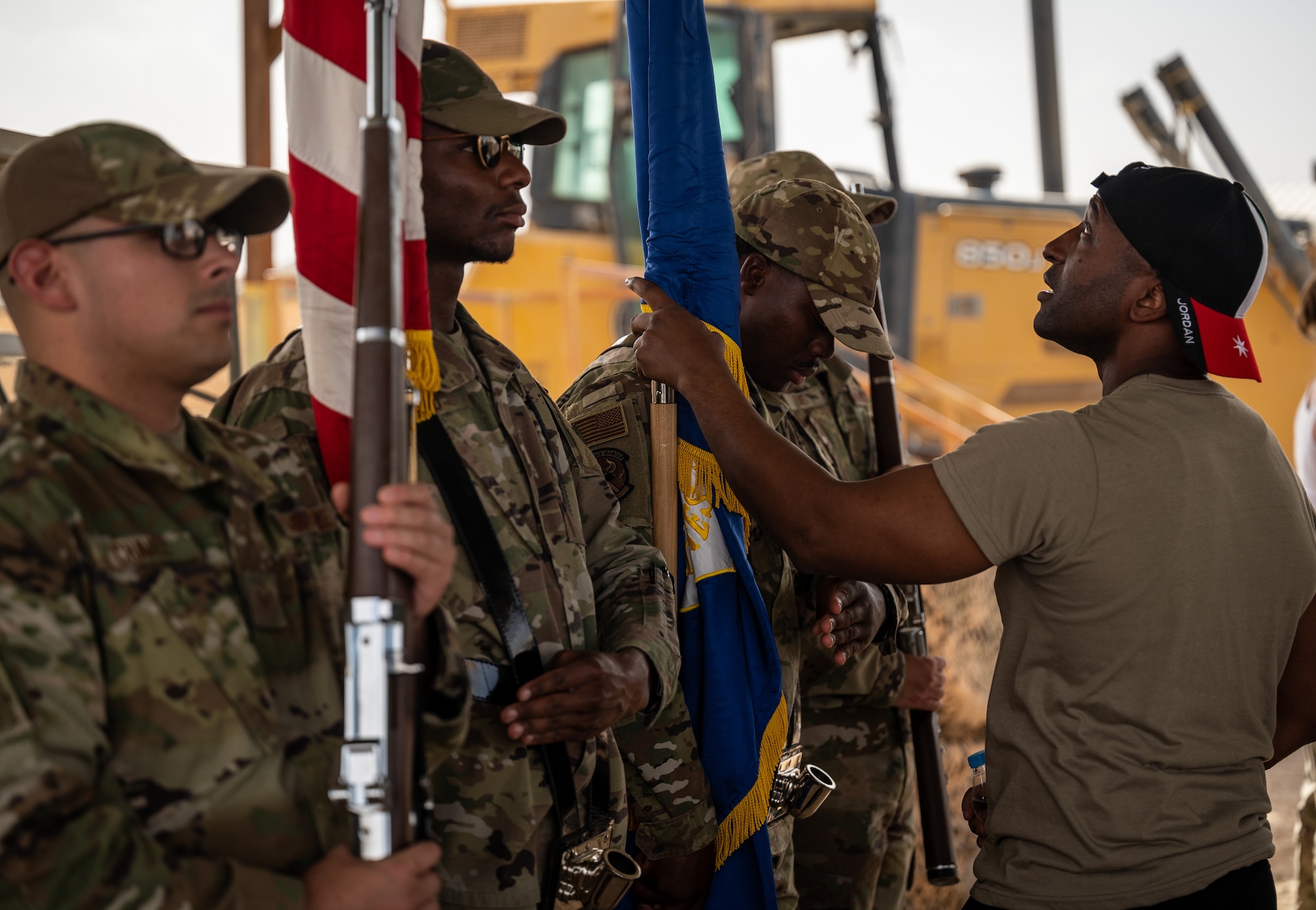 Technical Sgt. Jason Dixon, 332d Expeditionary Logistics Readiness Squadron aerial port superintendent and Base Honor Guard lead trainer, provides direction to BHG team members just before presenting the colors for an outdoor ceremony at an undisclosed location in Southwest Asia, May 27, 2022. The Honor Guard provides military ceremonial support and dignified transfer support when called upon. (U.S. Air Force photo by Master Sgt. Christopher Parr)