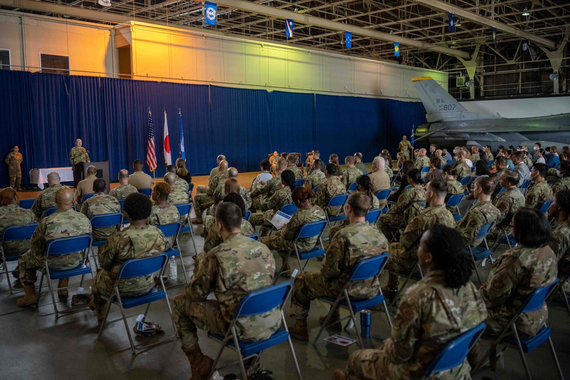 The commander speaks to a crowd at the change of command