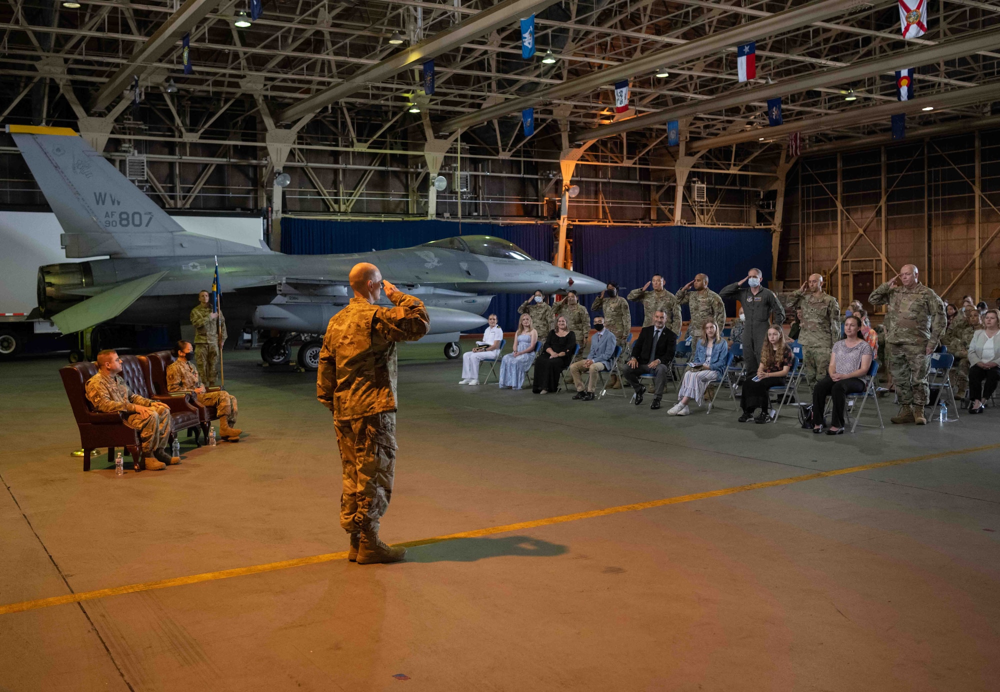 Military members salute one another in a crowd.