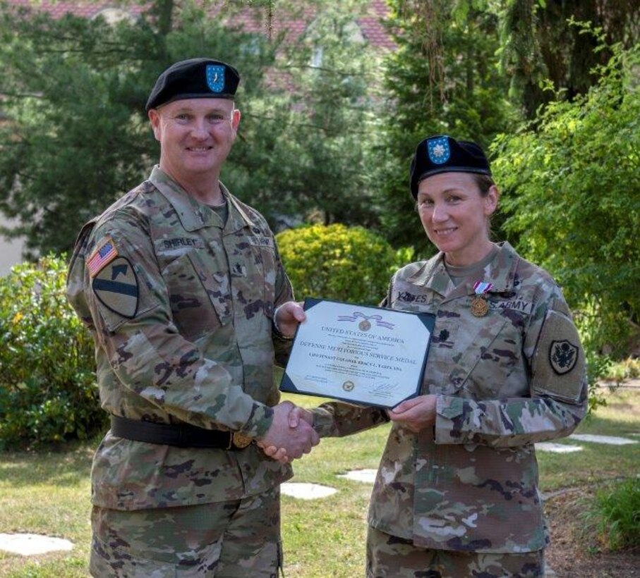 Army Brig. Gen. Eric P. Shirley, Defense Logistics Agency Troop Support commander presents the Defense Meritorious Service Medal to Army Lt. Col. Tracy L. Yates. As commander for DLA Troop Support Europe & Africa, she navigated Warfighter support through the COVID-19 pandemic and additional global crises.