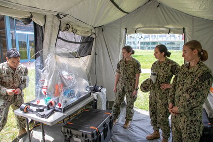 FREDERICK, Md. (June 3, 2022) Chief Hospital Corpsman Jan Marayag of Naval Medical Research Center’s (NMRC) Biological Defense Research Directorate (BDRD) demonstrates the use of a deployable containment kit, which provides a practical containment solution for field collection, containment, and decontamination. NMRC’s BDRD laboratory, located at Ft. Detrick, works to advance research and develop therapeutics to protect against biological attacks. (U.S. Navy photo by Michael Wilson /Released)