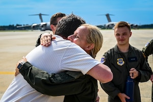 U.S. Air Force Colonel Michele Lo Bianco, 305th Operations Group commander, embraces a colleague following a fini flight on June 21, 2022 at Joint Base McGuire-Dix-Lakehurst, N.J. Lo Bianco will serve as the 15th Wing commander at Joint Base Pearl Harbor-Hickam.