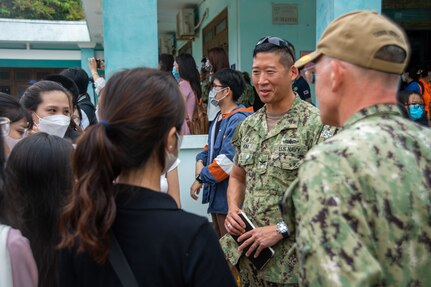 220623-N-AU520-1025 TUY HOA, VIETNAM (June 23, 2022) – Capt. Hank Kim, Pacific Partnership 2022 mission commander (middle), and Capt. Timothy Quast, Military Sealift Command hospital ship USNS Mercy’s (T-AH 19) commanding officer (right), talk with students from the Phu Yen Medical College during a health fair during Pacific Partnership 2022. Now in its 17th year, Pacific Partnership is the largest annual multinational humanitarian assistance and disaster relief preparedness mission conducted in the Indo-Pacific. (U.S. Navy photo