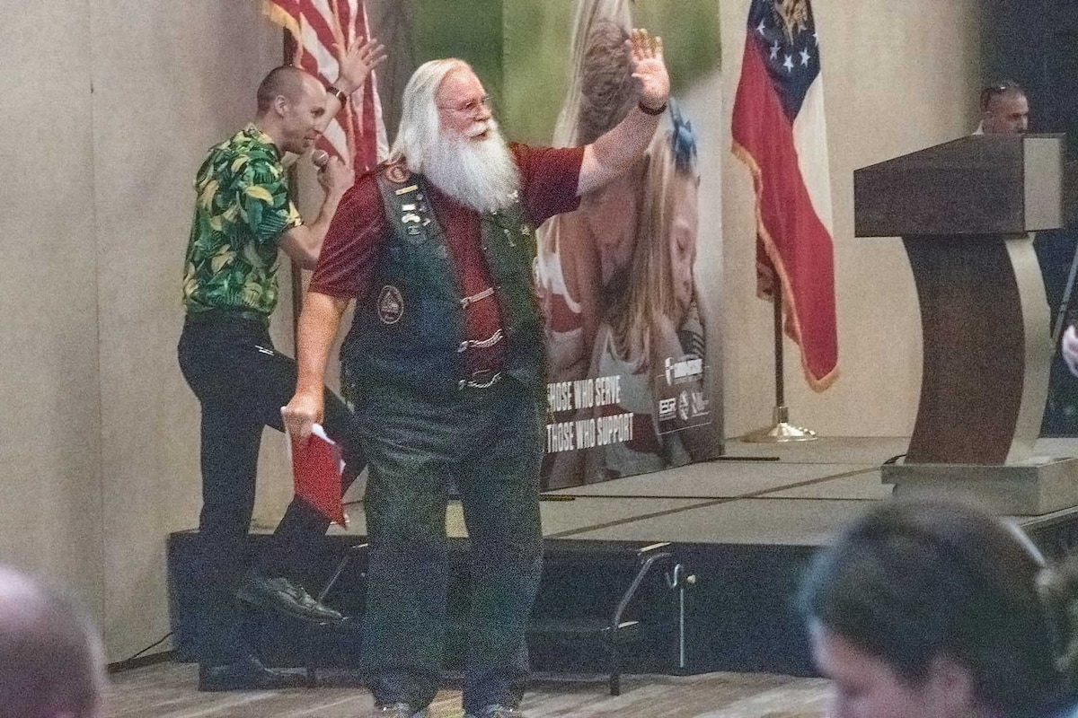 Photo of Mark Hyman, a volunteer with the Patriot Guard Riders, waiving to attendees at a Yellow Ribbon event in Atlanta, June 19.