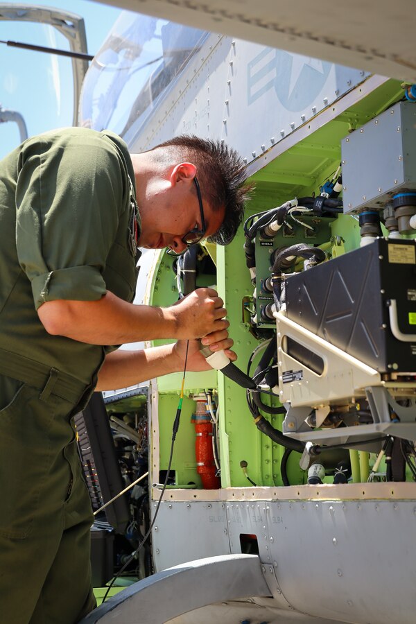 U.S. Marines with Marine Light Attack Helicopter Squadron (HMLA) 773 Detachment A, 4th Marine Aircraft Wing, conduct maintenance on an AH-1Z Viper during exercise Gunslinger 22 at Salina, Kansas on June 20, 2022. Routine aircraft maintenance is required to insure the aircraft is operating within optimal flight conditions. (U.S. Marine Corps photo by Cpl. Oscargavino Quintana)