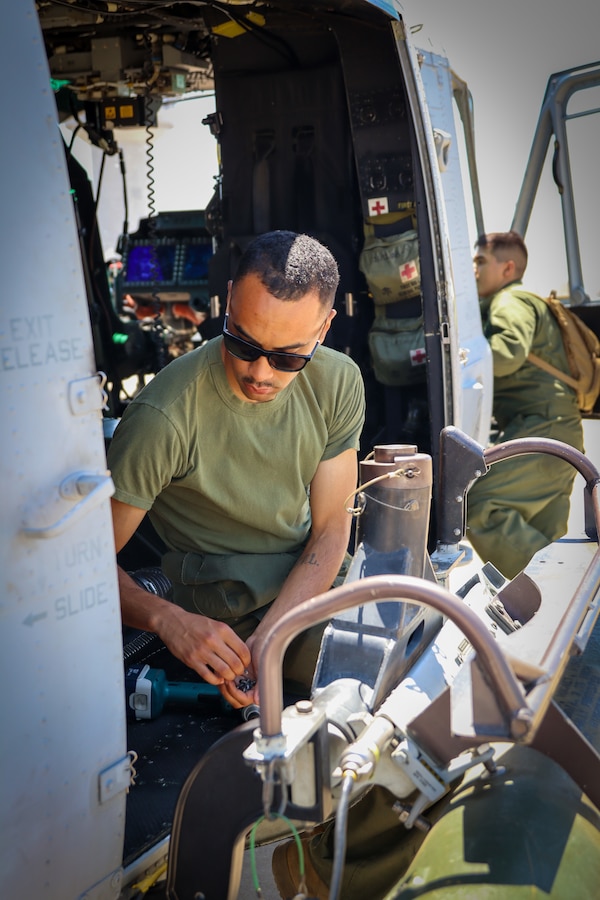 U.S. Marines with Marine Light Attack Helicopter Squadron (HMLA) 773 Detachment A, 4th Marine Aircraft Wing, conduct maintenance on an AH-1Z Viper during exercise Gunslinger 22 at Salina, Kansas on June 20, 2022. Routine aircraft maintenance is required to insure the aircraft is operating within optimal flight conditions. (U.S. Marine Corps photo by Cpl. Oscargavino Quintana)