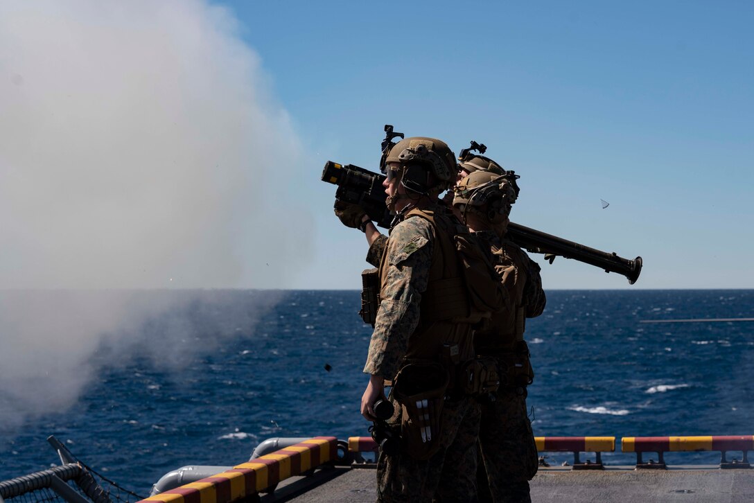 U.S. Marine Corps Cpl. Nicholas Longden and Lance Cpl. Romig Beley, both low altitude air defense gunners with the Air Combat Element of the 22nd Marine Expeditionary Unit, fire a FIM-92 Stinger during Fleet Battle Problem 22-1, aboard amphibious assault ship USS Kearsarge (LHD 3), March 20, 2022. FBP 22-1 integrates naval capabilities to support special operations, provide defense ashore and at sea, and develop the use of unmanned underwater vehicles.