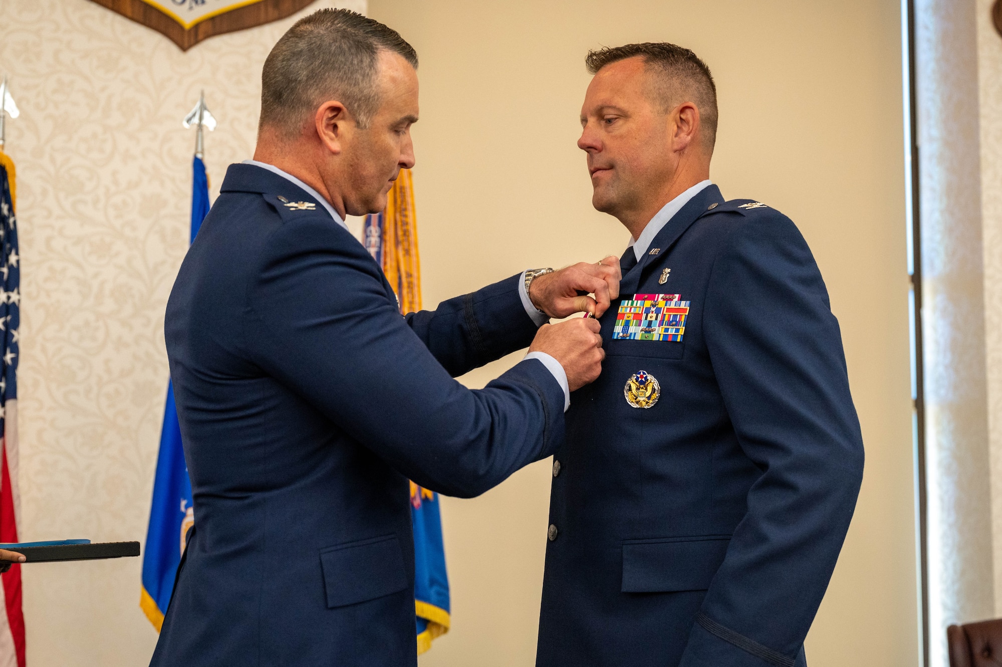 The pinning of an award during the change of command ceremony.