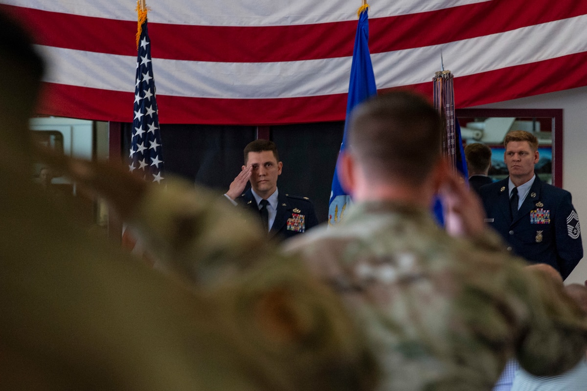 Lt. Col. Matthew Olson, outgoing 436th Civil Engineer Squadron commander, receives his final salute from Maj. Ben Johnson, 436th CES operations flight commander and commander of troops, during a change of command ceremony held at the base fire station on Dover Air Force Base, Delaware, June 23, 2022. Col. Phelemon Williams, 436th Mission Support Group commander, presided over the ceremony as Olson relinquished command to Lt. Col. Joshua Yerk. (U.S. Air Force photo by Roland Balik)